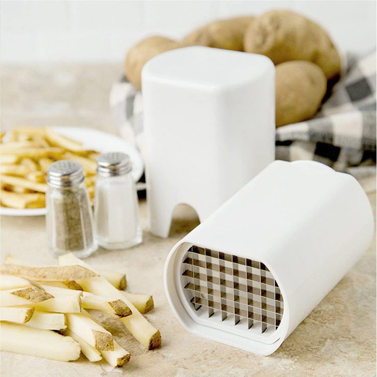 Compact homemade French fry cutter with stainless steel cutting grid and freshly cut potato sticks