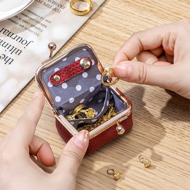 Open mini jewelry organizer holding rings earrings and small jewelry