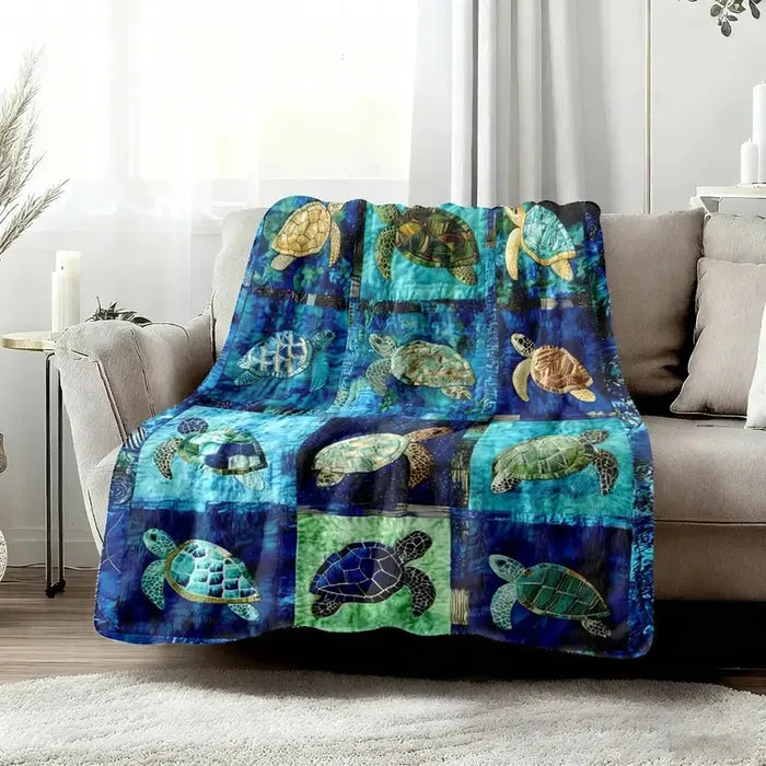 Ocean mosaic sea turtle flannel blanket draped across a soft neutral sofa in a bright, relaxing living room