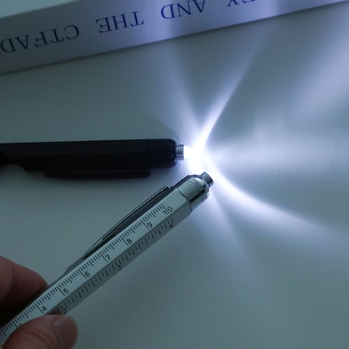 LED light on the 9-in-1 pen illuminating a dark surface