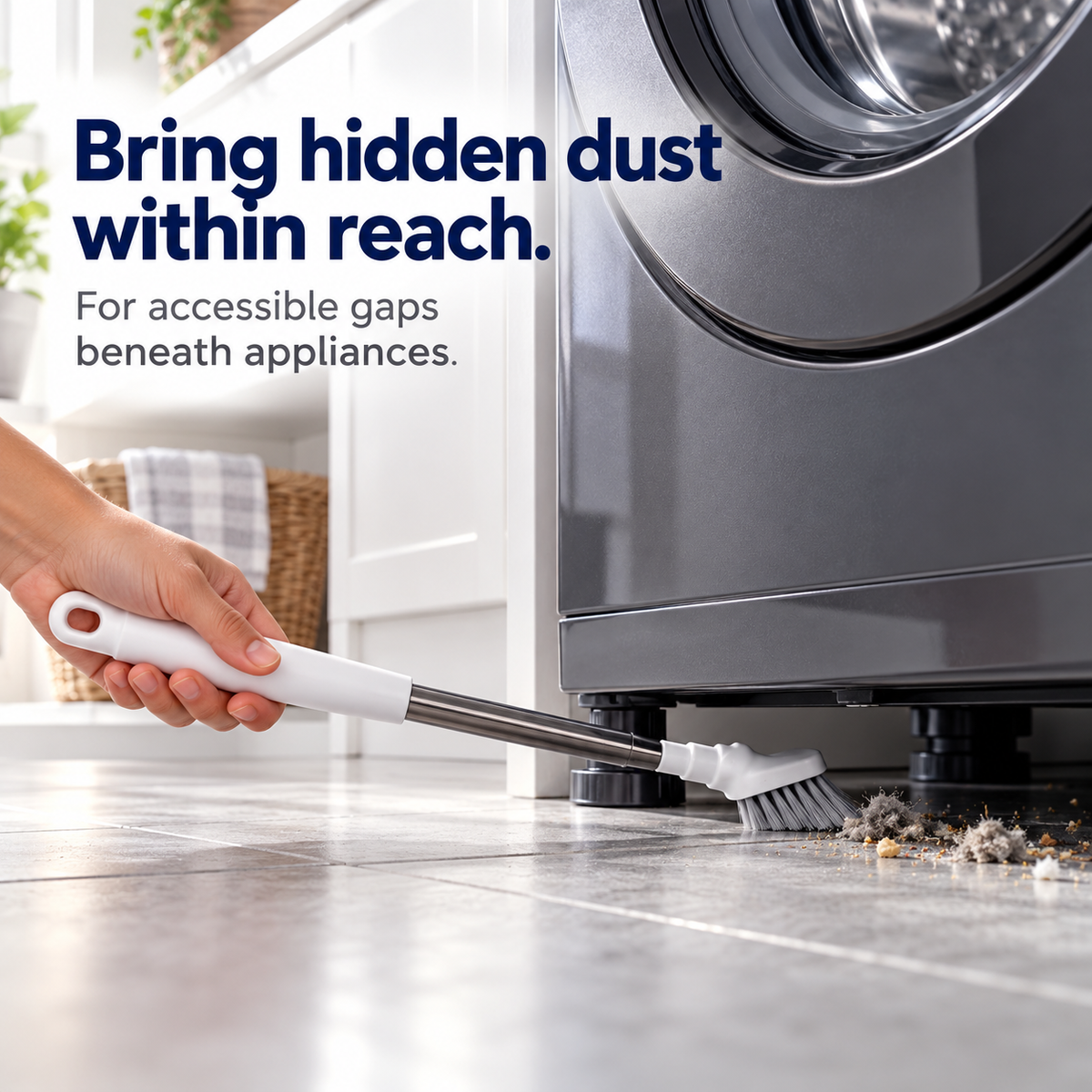 Extendable cleaning brush reaching under a washing machine to remove dust and crumbs