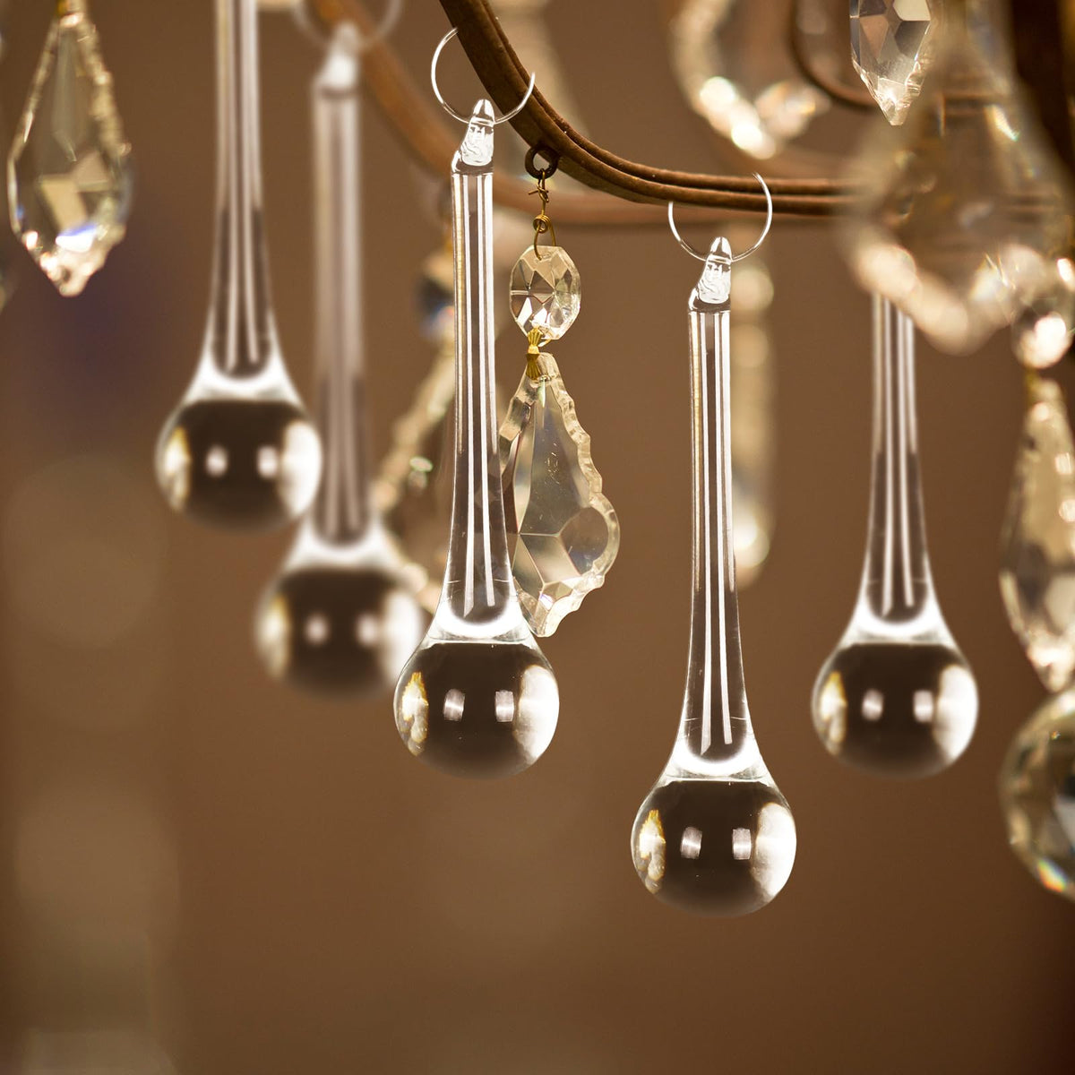Elegant clear decorative hanging teardrops surrounded by golden crystals