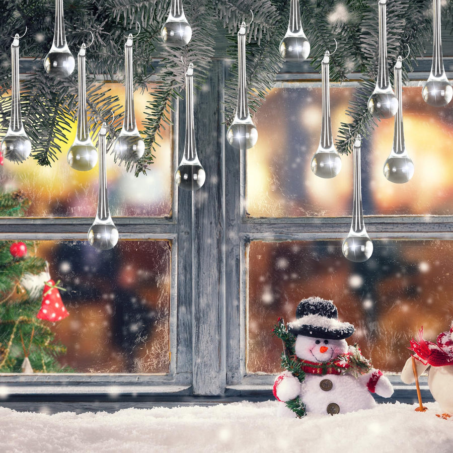 Winter window decorated with transparent crystal-style droplets and festive greenery